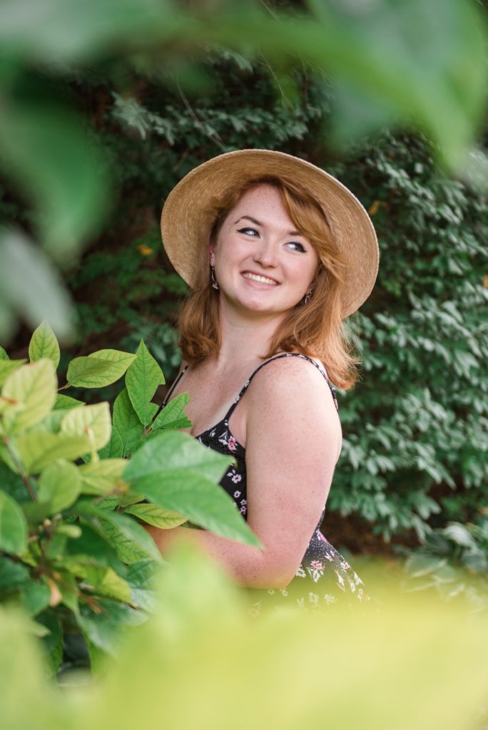 senior girl with hat in garden
